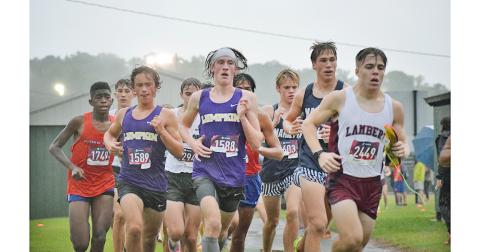 Lumpkin County High School runners, Wyatt Windham, left, and Ben Sherrill pushed through the sloppy conditions to finish with new personal records at the weekend meet in Pickens County.