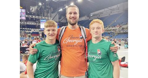 Lumpkin wrestling’s Team Georgia representatives at Nationals, from left, Nathan Nielsen, coach Will Johnson and Austin Marshall, competed in Fargo at what is known as the largest wrestling tournament in the world last month.