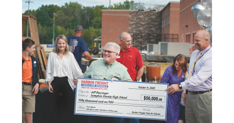 Lumpkin County High School teacher Jeff Bearinger receives a large $50,000 check from Principal Billy Kirk and Harbor Freight Regional Manager Lauren Gomez.