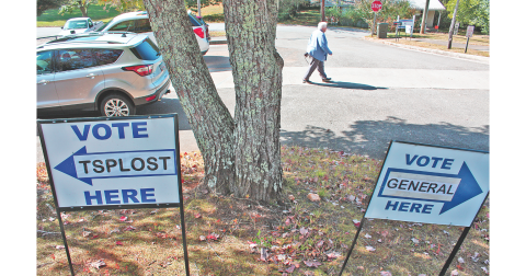 On Friday morning, a determined early voter strides between polling places on Short Street. (Photo by Keith Murden)