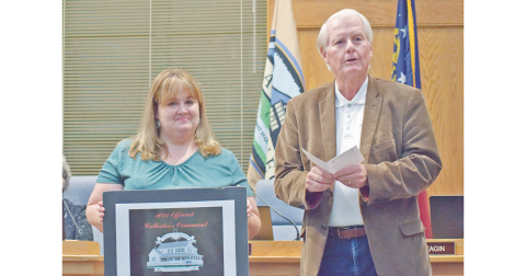 Community Helping Place Director Melissa Line stands alongside council member Ron Larson as the much anticipated CHP fundraising Christmas ornament was officially unveiled at last week's Dahlonega City Council meeting.