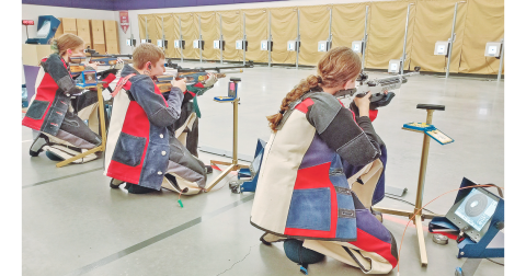 LCHS Rifle team sharpshooters, from left, Laura Hoch, Freshman JT Wright and Brynn Foster take aim while facing off against Riverside on November 15.