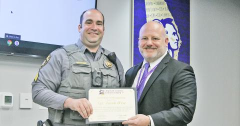Sergeant Jacob Wise is presented with the 2022 Georgia RISE Award by Lumpkin County Schools Superintendent Dr. Rob Brown.