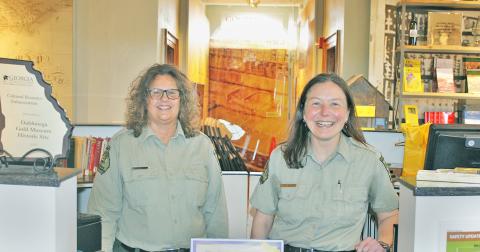 Tour Guide Charlotte Lindley (left) and Site Manager Heather Abercrombie are ready to greet guests at the historic Dahlonega Gold Museum.