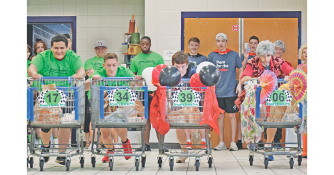 The inaugural Grocery Grand Prix was not only an action-packed event but a profitable fundraiser for the Community Helping Place Food Bank on Saturday. The competition was originally scheduled to take place on the Lumpkin County High School track but moved indoors to the cafeteria due to weather, which made for some tight turns and raucous racing. (photo by Matt Aiken/The Nugget)
