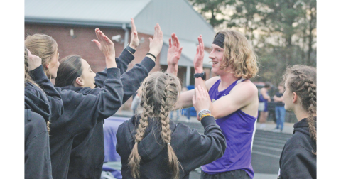 Lumpkin County runner Ben Sherrill celebrates his first pace finish in the 3200-meter event at the Gilmer County meet.