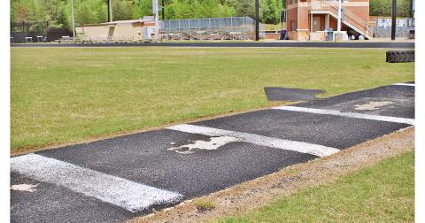 The pole vault approach, situated in the middle of the LCHS track, currently has several large divots that coaches have to cover with rubber scraps for athletes' safety.