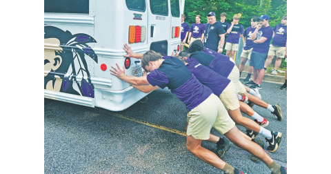 The LCHS football team competes in their first summer burn competition where they raced to push a bus over a long distance.