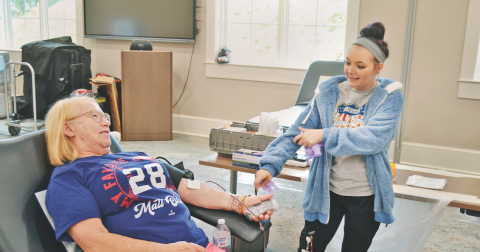 Reba Rider is ready to donate blood at the Lumpkin County Library under the watch of Alyssia Zoller.