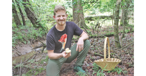Certified mushroom identification expert and Mindfull Mycology owner Sam Blackstone shows off a wild mushroom he spotted while foraging on his 40-acre property just outside of Dahlonega.