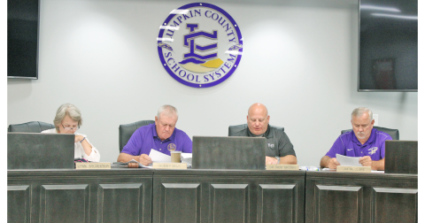 Lumpkin County School Board members compare notes as they deliberate the tentative millage rate for Fiscal Year 2024. Pictured (from left) are Lynn Sylvester, Chairman Bobby Self, Superintendent Rob Brown and Jim McClure.