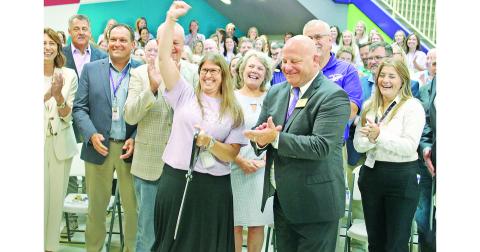 Cottrell Elementary Principal Stacie Gerrells celebrates next to Superintendent Rob Brown and other officials after cutting the ceremonial red ribbon to mark the grand opening of the new school.