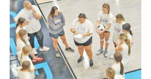 The Lumpkin volleyball team discusses their game plan ahead of the scrimmage game.