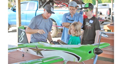 NGMA member Ron Gaynor explains the basics of lift, weight, drag and thrust to Judah Payne, 7, Noah Wade, 14, and Trevor Wade during the club’s recent Junior Flight Academy event.