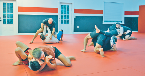 Students grapple with their rolling partners during a lively session at Dahlonega Brazilian Jiu Jitsu.