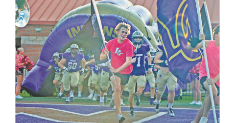 The Lumpkin Crunk Crew and Indians football team storm the field ahead of their game against Banks County.