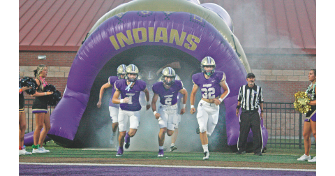 The Indians storm the field ahead of their season opener against Union County on Friday night.