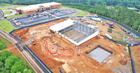 A drone photograph by Carroll Daniel Construction on August 11 shows an aerial view of the progress at the Pinetree Recreation Center site. Cottrell Elementary School is visible in the background.