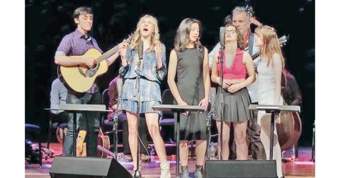 Local artist Mia Dierkes, second from left, takes to the stage in Memphis, Tennessee to close out the Acoustic Music Project.