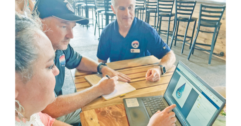 Members of the Six Gap Organizing Committee, from left, Mea Inglehart, Joe Coddington and Robb Nichols work on the new logo for their 6G2 Gravel Ride. They hope to expand the Six Gap brand to include five races throughout the year.