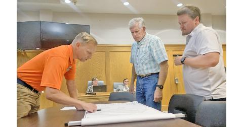 City Engineer Mark Buchanan, left, describes the layout for the upcoming Whataburger franchise property as council members Ross Shirley, middle, and Ryan Reagin look on.