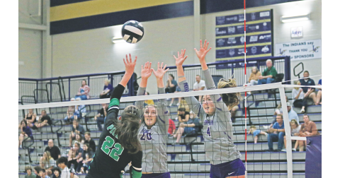 Morgan Powell, right, and Mary Richardson attempt to make a block at the net.