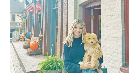 Business owner Abigail Camilleri and her local pup Dilly, celebrate their one year anniversary of opening up their shop on the Public Square.