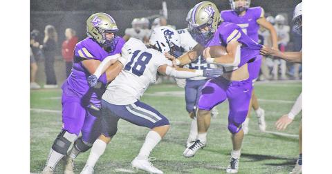 Mason Sullens powers his way downfield as Lane McColeman lays down a block during Lumpkin’s thrilling win over region rival White County.