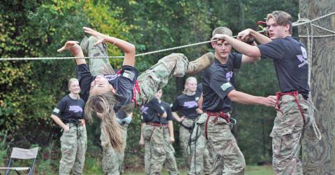 McKinzley Cootware, Sid Braswell and Colton Gilreath work together as a team during the rope bridge event.