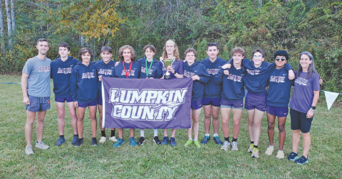 The Lumpkin County boys cross country team won the school’s first cross country region championship last week at the 7-AAA meet at Unicoi State Park near Helen. Members of the team are, from left, head coach Logan Turner, Peter Bowden, Evan Good, Hagen Glenn, Wyatt Windham, Sam Edwards, Ben Sherrill, Jackson Marling, James Bowden, Cooper Marling, Jacob Matthews, Paulo Ramirez and assistant coach Teri Hilchie. (photo by Mark Turner)