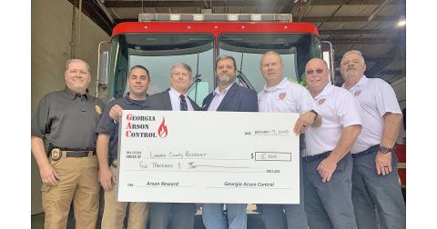 Officials gathered at the downtown fire station recently to hand out a $5,000 reward to a local citizen who provided crucial information in the investigation of a 2021 arson case. On hand were, from left, State Fire Investigator Brian Smith, LCSO Investigator Heath Higman, District Attorney Jeff Langley, Georgia Arson Control consultant Ken LeCroy, Fire Marshal Chris Maloney, Fire Chief David Wimpy and Deputy Fire Chief Tony Kent.
