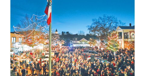 Thousands of visitors and locals filled the downtown area for the lighting of the square on Friday.  Local musicians Radford Windham and Chuck Bell filled the night air with holiday music before and after.  On hand to perform the ceremonial lighting of the square were UNG President Michael Shannon, Dahlonega Mayor JoAnne Taylor and Lumpkin County Chairman Chris Dockery. (Photo by John Bynum)