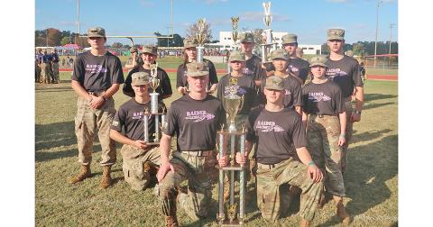 The Lumpkin County Raiders team shows off their new hard-earned championship trophies. 