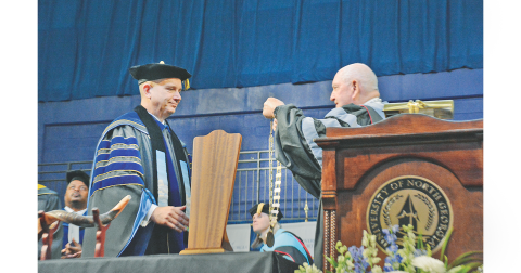 Sonny Perdue, the University System of Georgia Chancellor, performs the investiture of Michael Shannon while the audience looks on at the UNG convocation center.  During his inaugural address, Shannon reminded the audience of his goal to make UNG the most innovative, dynamic legacy making institution in the country. “College changes everything,” he said. “We will teach every student how to think, not what to think.”