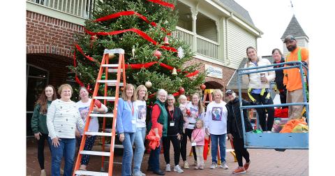Volunteers from the Old Fashioned Christmas Committee helped City employees to decorate the Christmas tree in front of the Visitors Center last week in preparation for a month of holiday celebrations in downtown Dahlonega. (Photo by John Bynum)