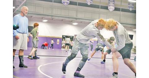 Coach Sean Hage watches wrestlers Austin Marshall and Jacob Pricer to make sure they get the most of their training ahead of the upcoming season.