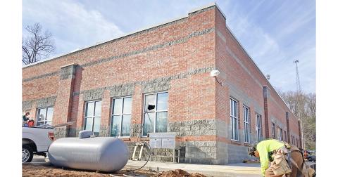 A construction worker labors outside the new Lumpkin County College & Career Academy building on the LCHS campus.