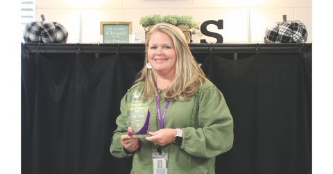 Kelly Seabolt displays her 2025 Teacher of the Year award for Long Branch Elementary.
