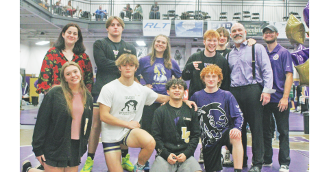 Head Coach Sean Hage and Coach Cale Goss gather with the Lumpkin wrestling seniors.