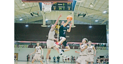 Lumpkin County junior Cal Faulkner drives for a big basket over region rival Dawson County last week. (Photo by Eligha Roper/The Nugget)