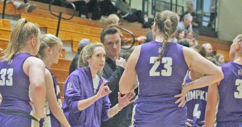 Lumpkin County girls Head Coach Tess Wright takes a moment with her team during a recent game.