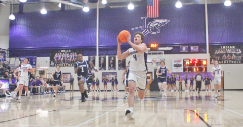 Lumpkin County’s Walker Scott races down the court for a breakaway layup.
