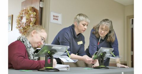 Local election officials (from left) Brittani Conner, Robin McIntosh and Crystal Dozier use a poll pad to activate ballot cards for testing ahead of the upcoming Presidential Preference Primary.