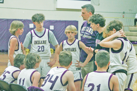 The Lumpkin County seventh grade boys team rallies during a time out.