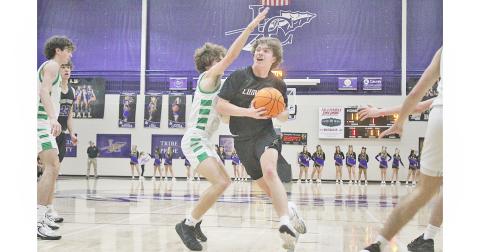 Lumpkin County’s TJ Gaddis powers his way in for a layup.