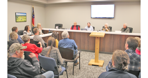 A capacity crowd gathered inside and outside the planning commission meeting room Monday night to make their voices heard on a proposed mixed use development for Dawsonville Highway and Pink Williams Road.