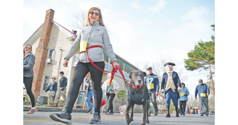 Dahlonega resident Penny Sharp and her dog Clarence Oddbody make up some time as they race through downtown in the Wimpy Mile.