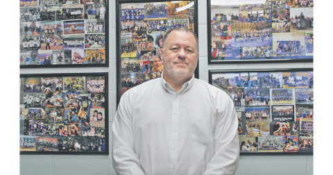 Brian Matthews has collages of photos from 15 years of coaching football hanging on the wall in his middle school office.