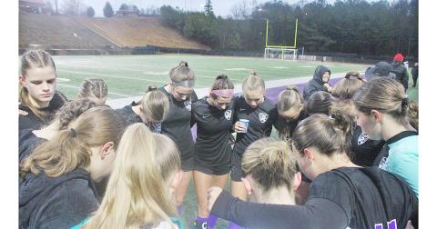 The Lumpkin County High School girls’ soccer team takes a moment before their big game.