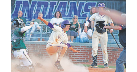Lumpkin County's Alejandro Narvaez calls himself safe after sliding into home plate. 
